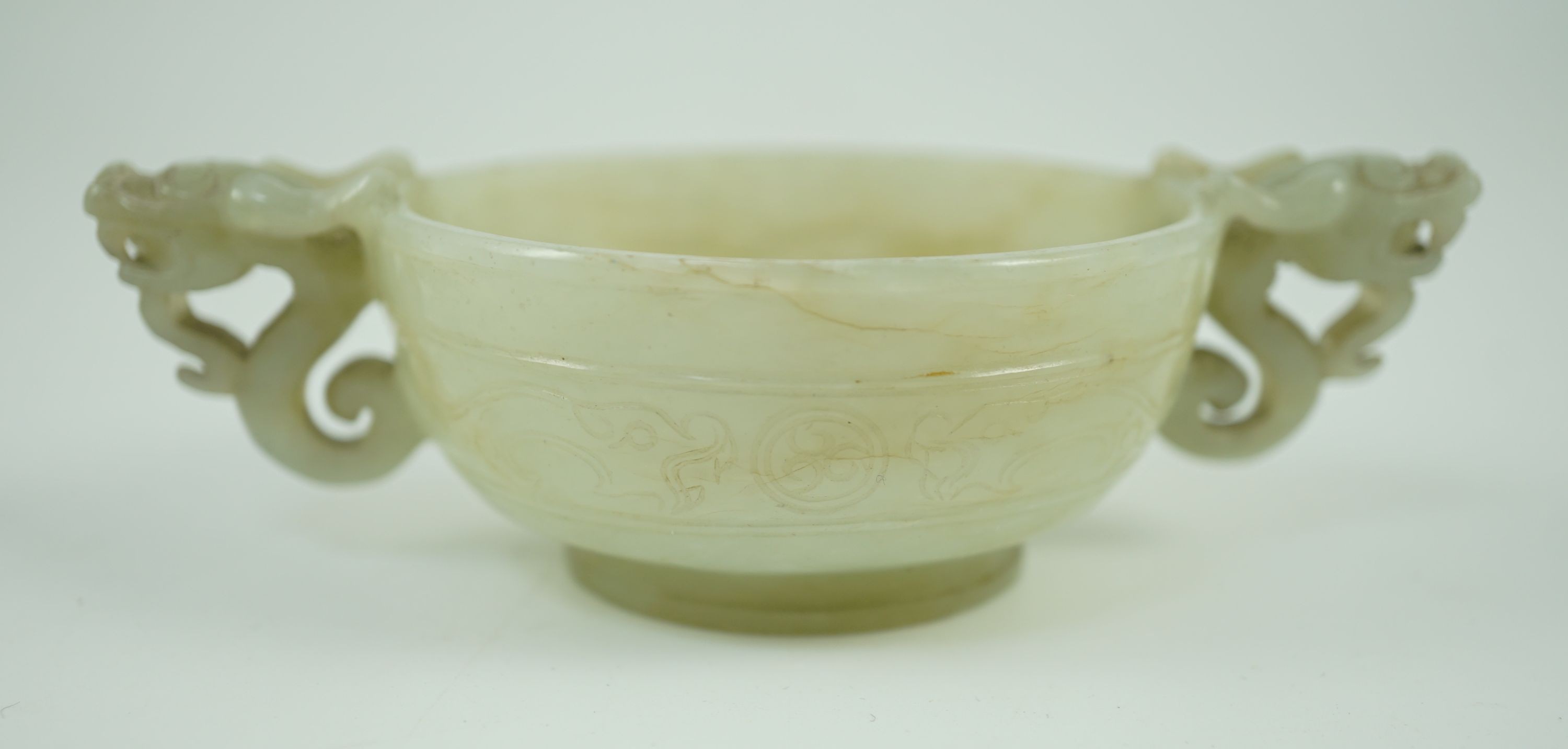 A Chinese pale celadon jade two handled ‘chilong’ cup, 17th/18th century, 13.2cm wide